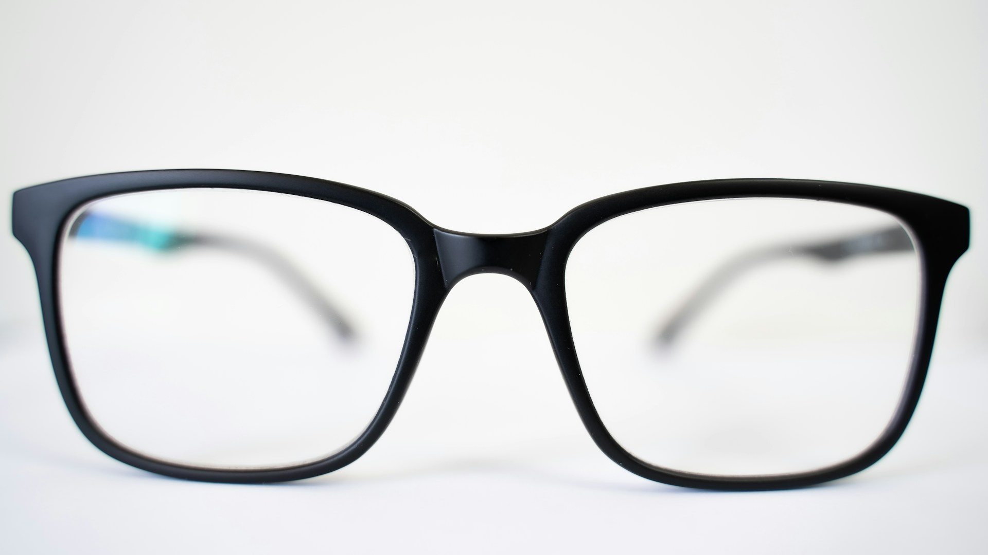 a pair of glasses sitting on top of a table