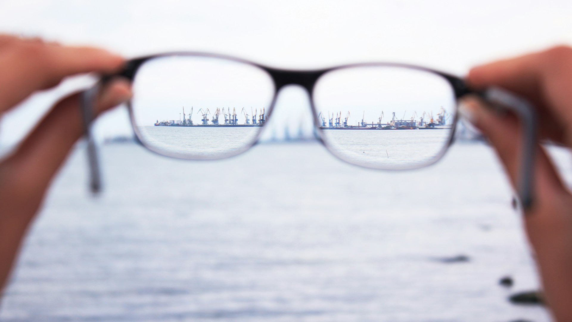 person holding eyeglasses