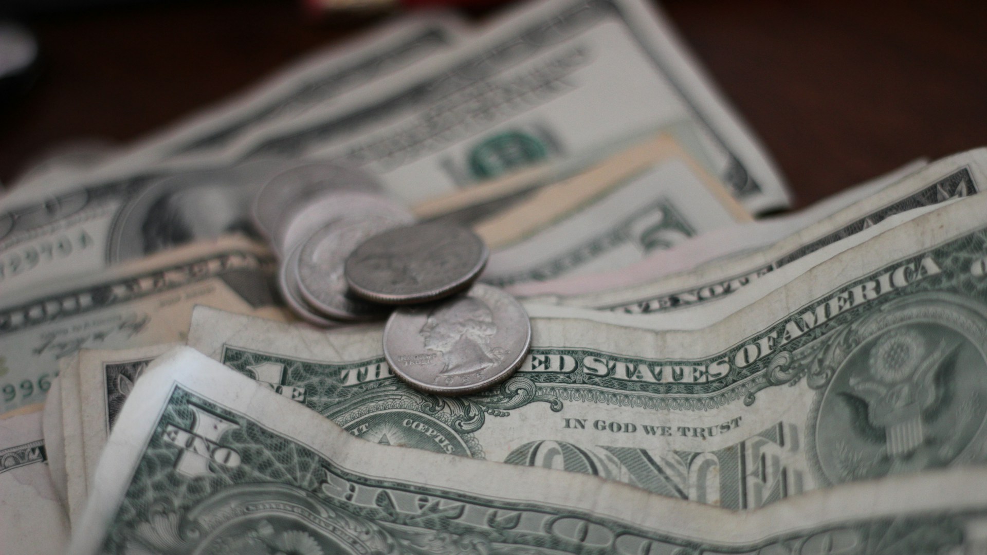 photo of dollar coins and banknotes