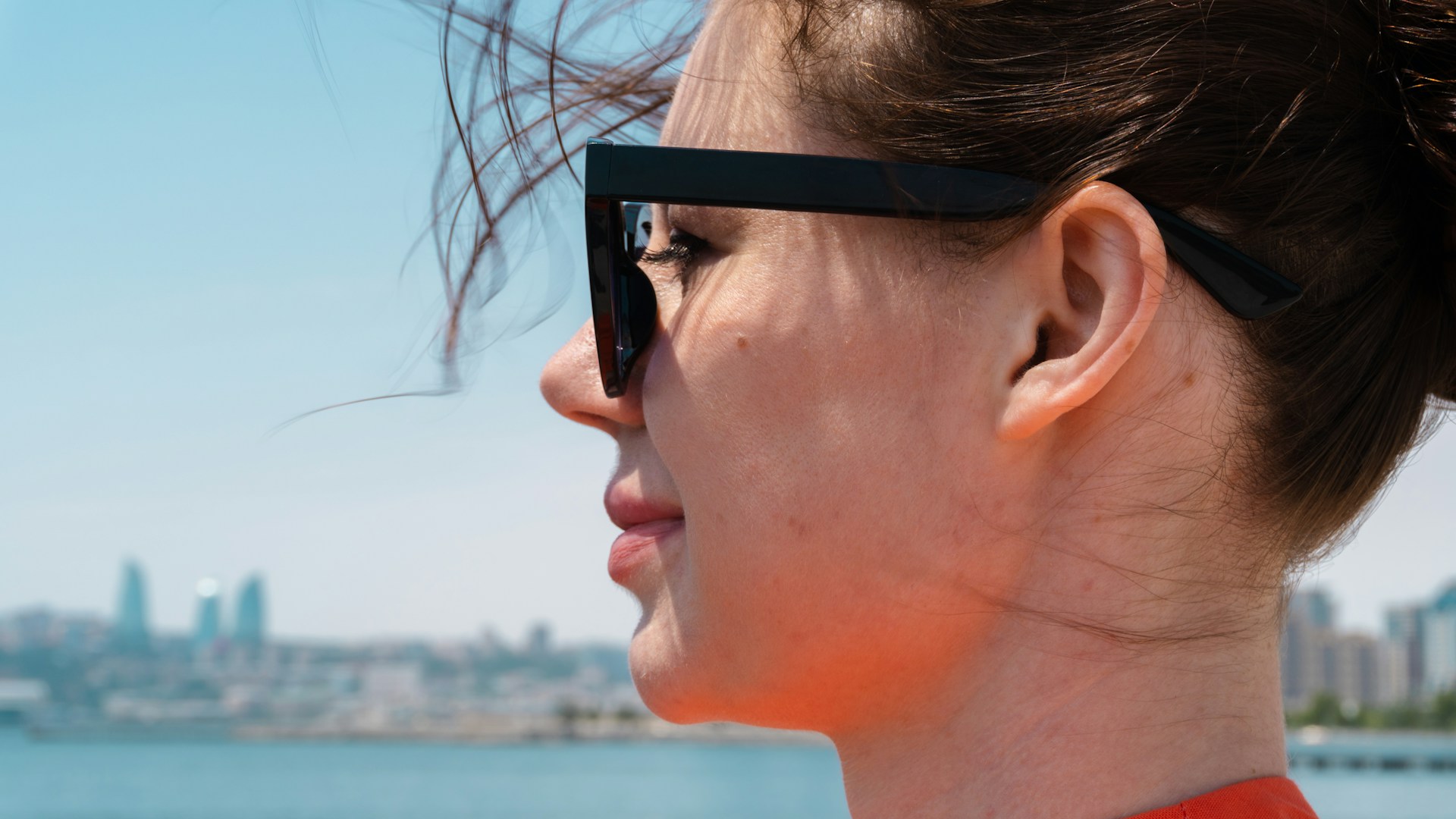 Woman wearing sunglasses by the water