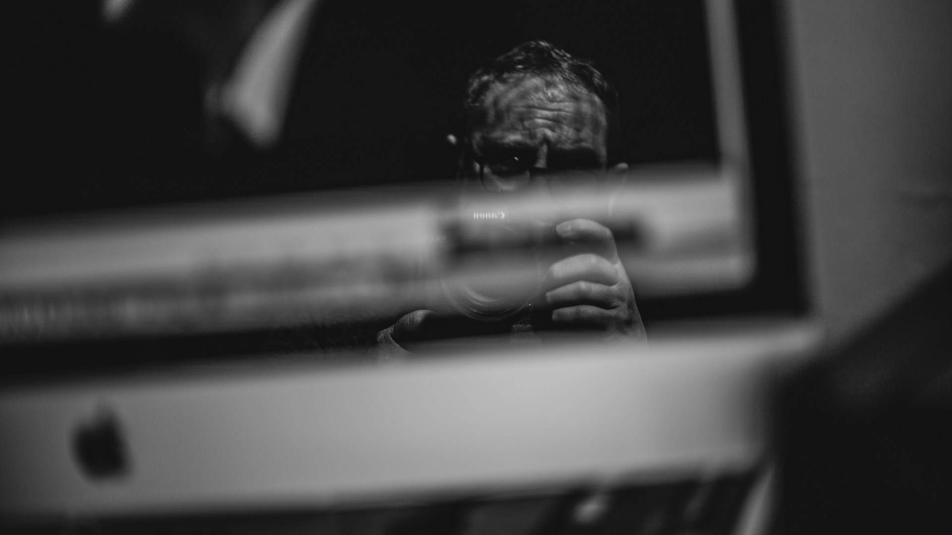 Man reflected in a computer screen