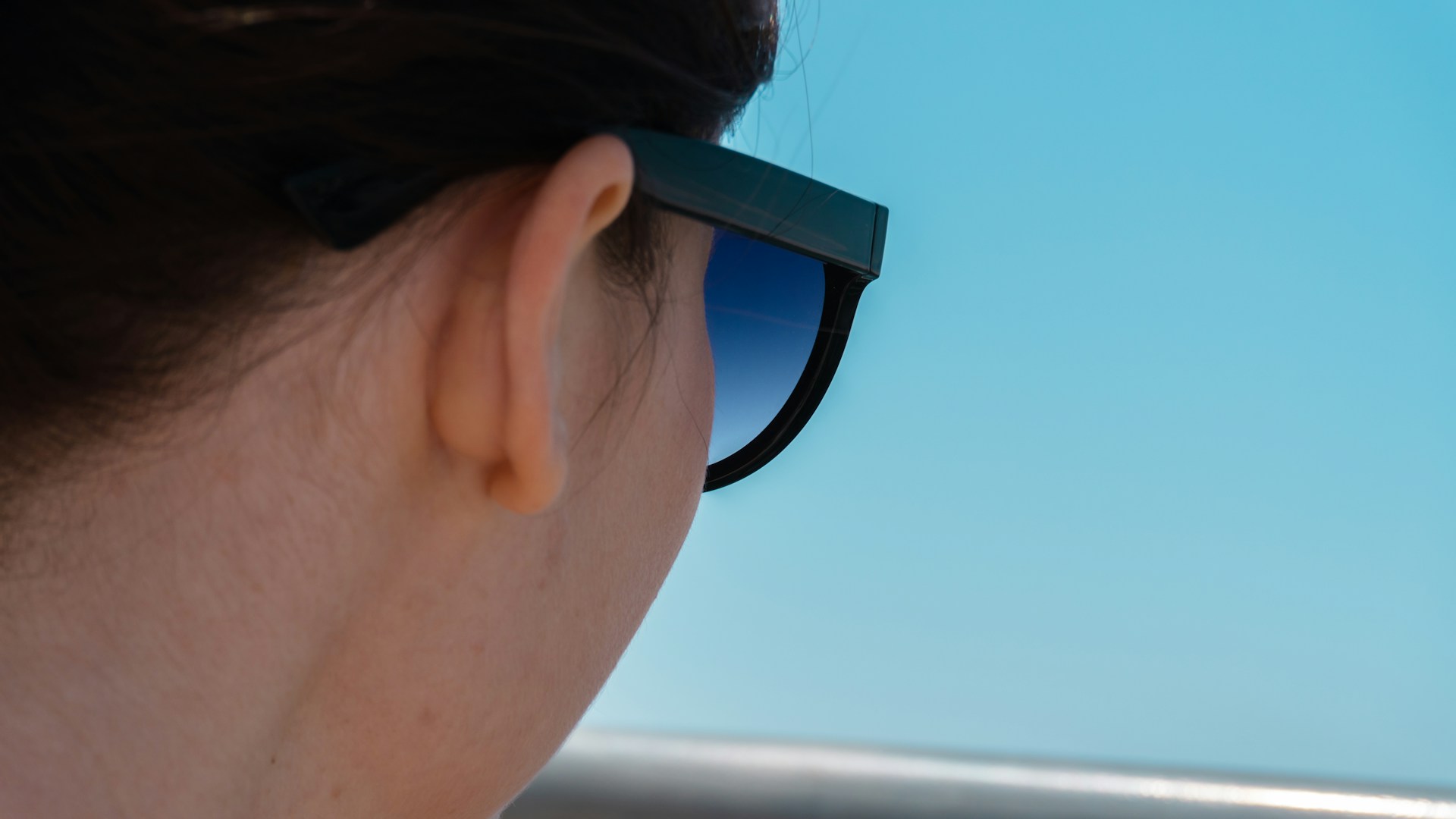 Woman wearing sunglasses looking at the sky
