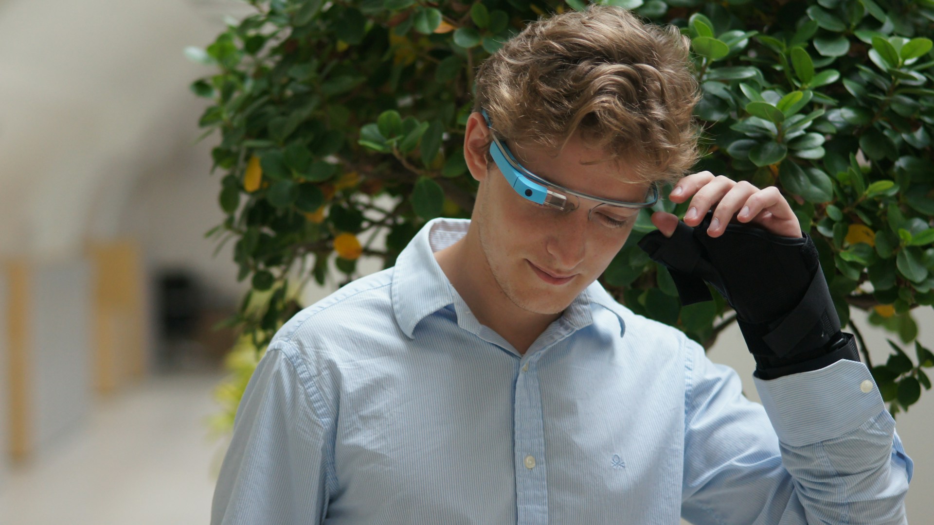 man in blue dress shirt wearing blue framed eyeglasses