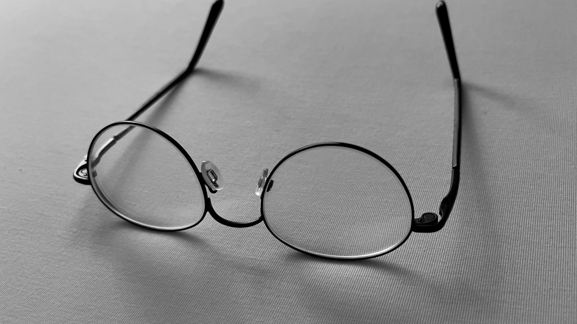 a pair of glasses sitting on top of a table
